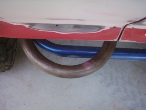 1978 Ford Bronco - Close-up view of the undercarriage of a vehicle, showing an exhaust pipe and frame components.
