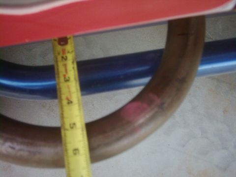 1978 Ford Bronco - A yellow tape measure is used to measure a metal pipe, with the Supermotors.net logo in the corner.