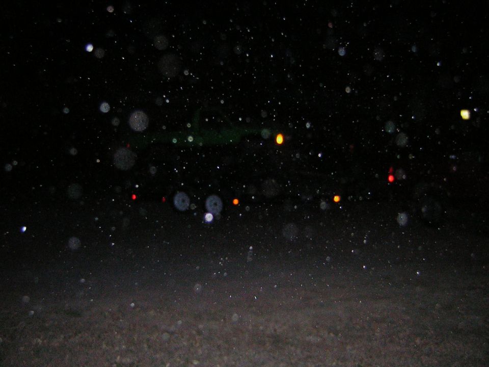 Nighttime scene with many out-of-focus lights and particles in the air