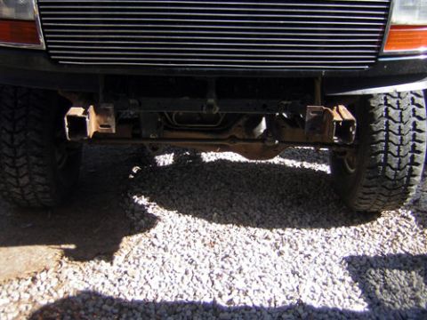 1995 Ford Bronco - Close-up of front bumper mounting brackets and tires, likely from an older truck or SUV.
