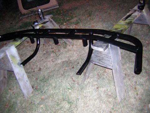 1995 Ford Bronco - A black metal bumper is shown on sawhorses, possibly being painted or repaired.