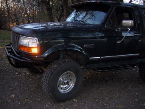 1995 Ford Bronco - This 1995 Ford Bronco features a custom bumper and fender flares, seen from the front quarter angle.