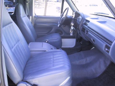 1993 Ford Bronco - Interior view of a blue-seated Ford truck, showing the dashboard and front seats.