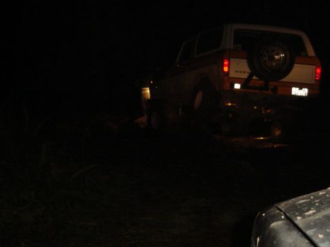1987 Ford Bronco - A 1987 Ford Bronco is seen from the rear at night, with its spare tire mounted externally.