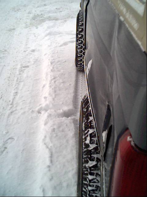 1987 Ford Bronco - The vehicle's tire treads are visible as it sits in the snow.