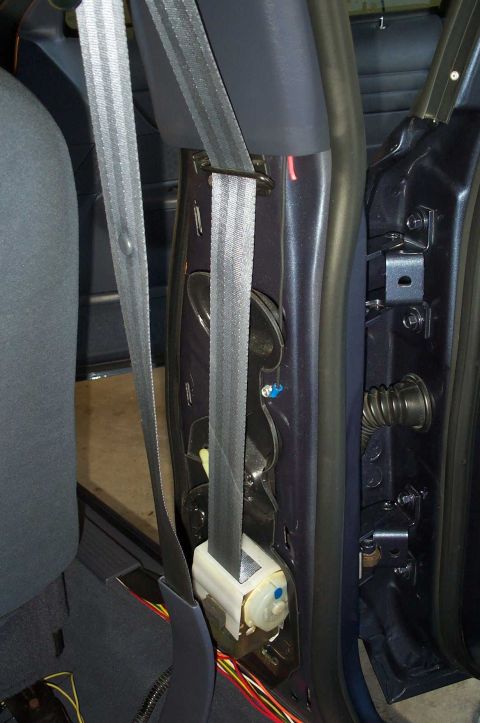 1998 Ford Crown Victoria - To gain access to the wiring tunnel between the body and the door, you must remove the panel that covers the seat belt track.