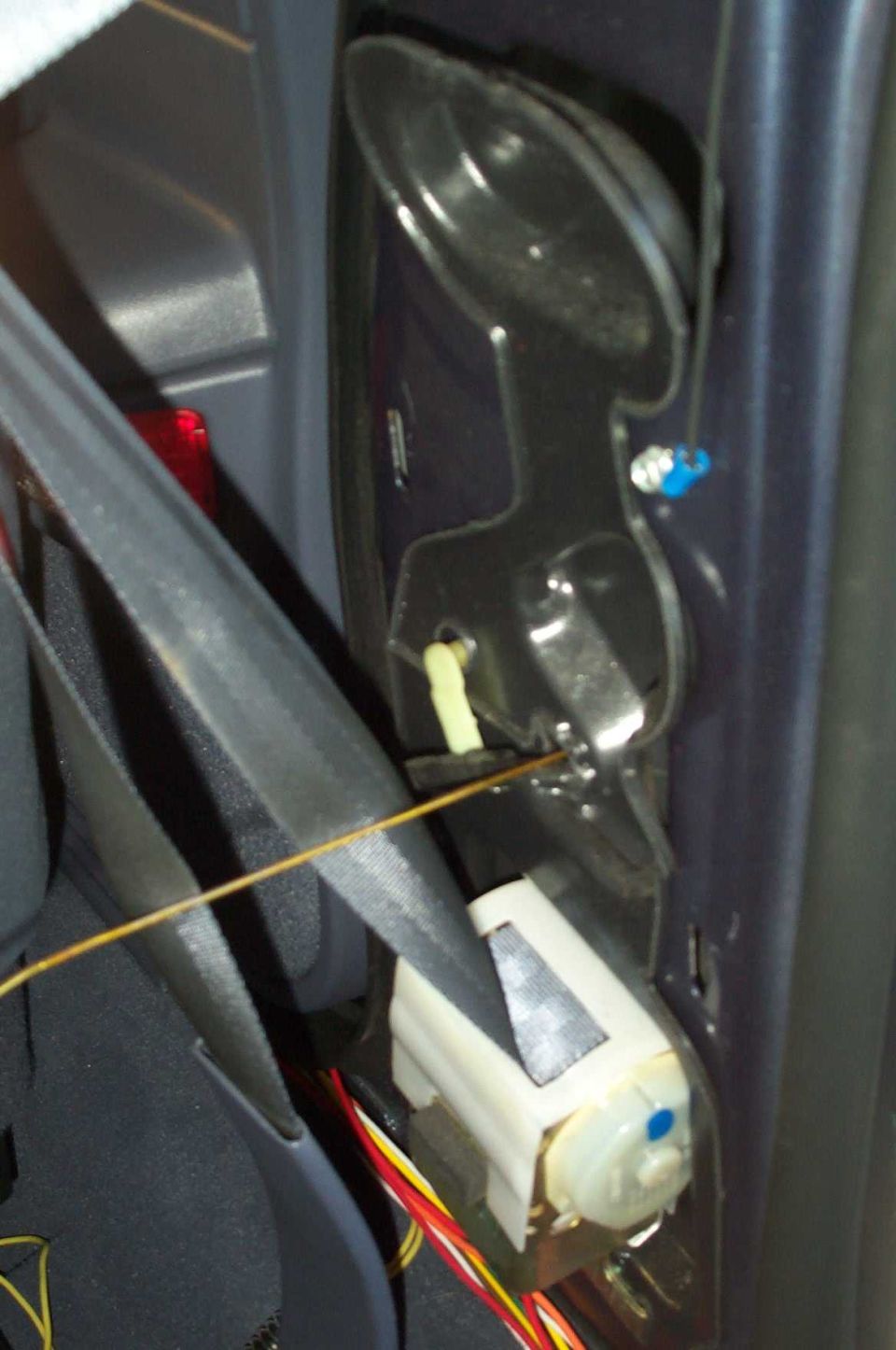 I used a coathanger to snake up through the door. Note the cut red wire and ground wire. Apparently something else from my Vic's days with the Feds.