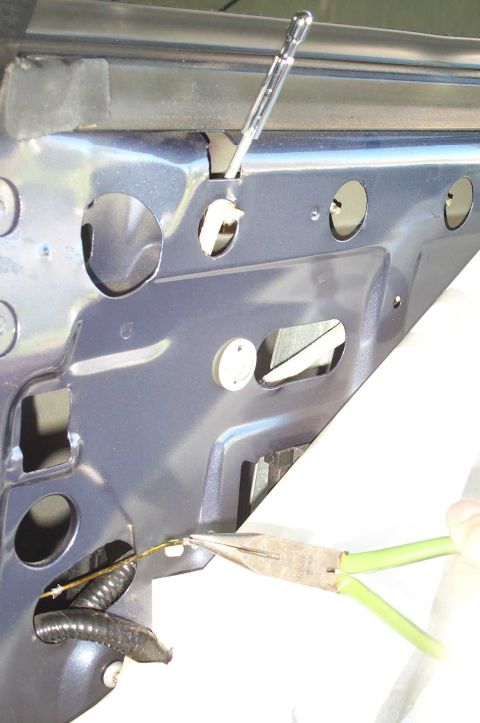 1998 Ford Crown Victoria - There is little space inside the doors, so I used pliers to grab the end of the coathanger and pull it through.