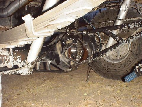 1988 Ford Bronco - Underside view of a vehicle's rear axle assembly and suspension components.