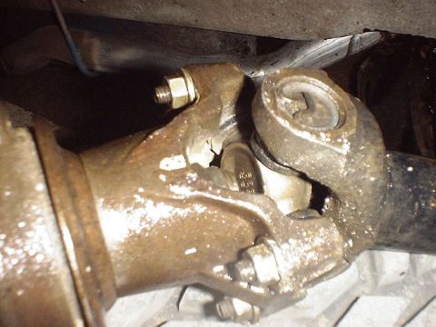 1988 Ford Bronco - Driveshaft universal joint showing signs of wear and grease accumulation.
