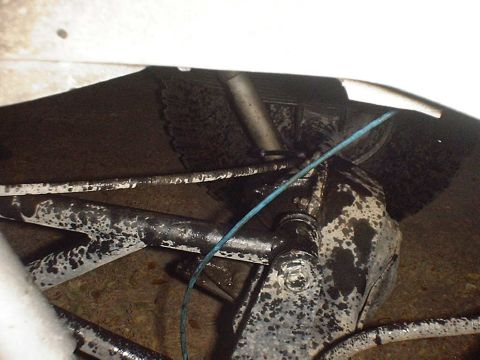 1988 Ford Bronco - Undercarriage view shows suspension components and a blue wire, likely from a truck or SUV.