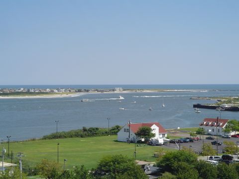1990 Ford Bronco - A wide shot captures a bay dotted with boats, bordered by a town and a grassy area with buildings.