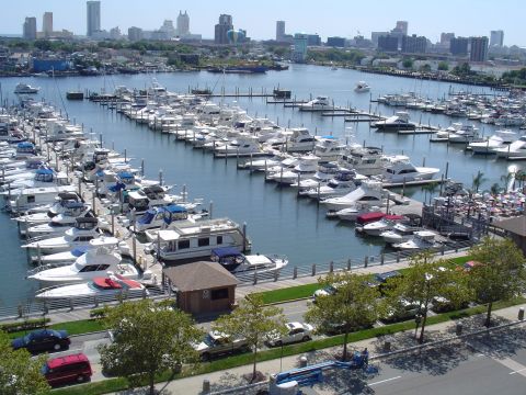 1990 Ford Bronco - A wide view of a marina packed with numerous boats, with a city skyline visible in the distance.