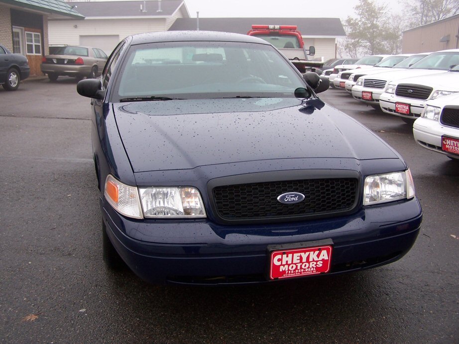 Dark blue 2001 Ford Crown Victoria front view with black grille and dealer plate