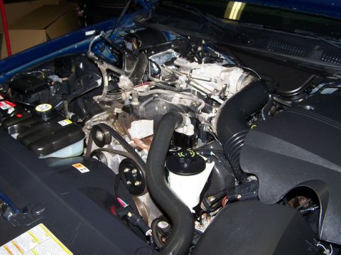 2001 Ford Crown Victoria - Plastic top is off and alternator is being swapped.