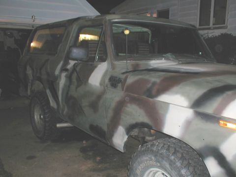 1979 Ford Bronco - This 1979 Ford Bronco features a camouflage paint job and is viewed from the front three-quarter angle.
