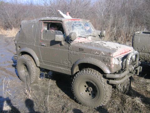 1994 Ford Bronco - This Suzuki Samurai is covered in mud after an off-road adventure.