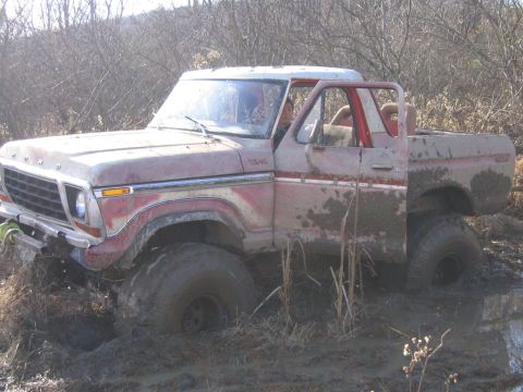 1994 Ford Bronco - This 1978 Ford Bronco is stuck deep in the mud, with its front tires submerged.