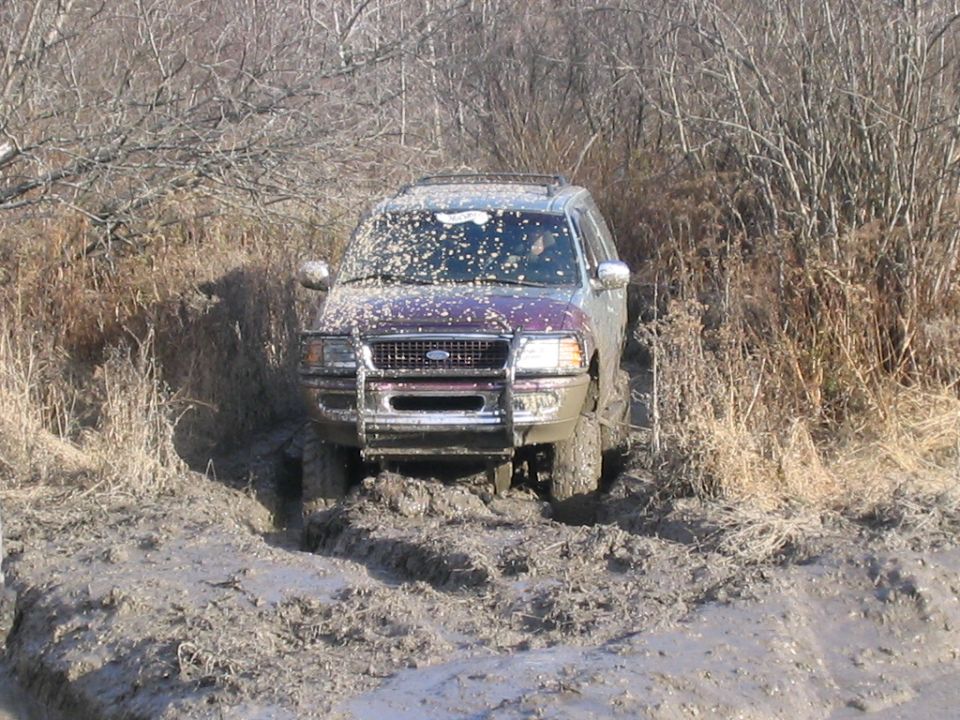 Ford Expedition stuck in mud, covered in mud splatters