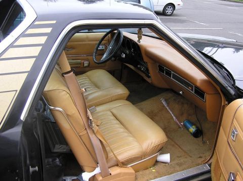 1973 Ford Ranchero - The interior of a 1973 Ford Ranchero shows tan upholstery and a dashboard with visible wear.