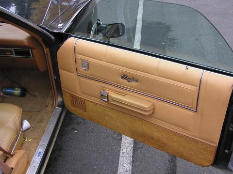 1973 Ford Ranchero - The interior door panel of a 1973 Ford Ranchero displays its model name and tan upholstery.