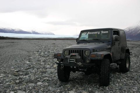 2003 Jeep TJ - 2003 Jeep TJ Rubicon parked on a rocky shore with a glacier and mountains in the background.