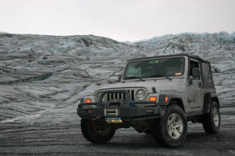 2003 Jeep TJ - A silver Jeep Wrangler Rubicon is parked on a glacier with icy terrain in the background.