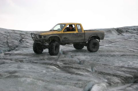 2003 Jeep TJ - A heavily modified pickup truck navigates the icy terrain of a glacier.