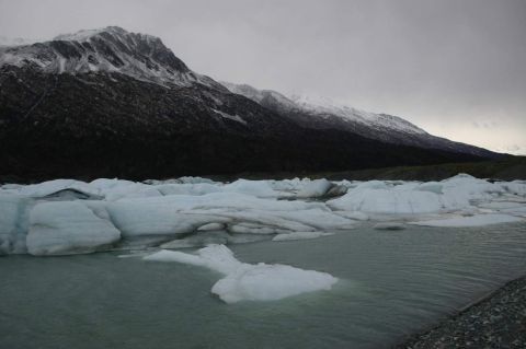 2003 Jeep TJ - A glacial landscape with ice formations scattered across the water, under a dramatic, overcast sky.