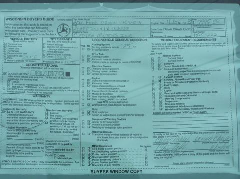 2001 Ford Crown Victoria - A Wisconsin Buyers Guide document details a vehicle's history and condition, with handwritten information about the make, model, and seller.