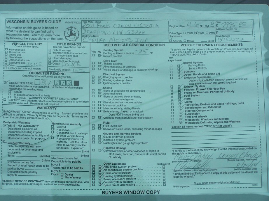 Wisconsin Buyers Guide document with handwritten "2001 Ford Crown Victoria" and "Cheyka Motors Inc."