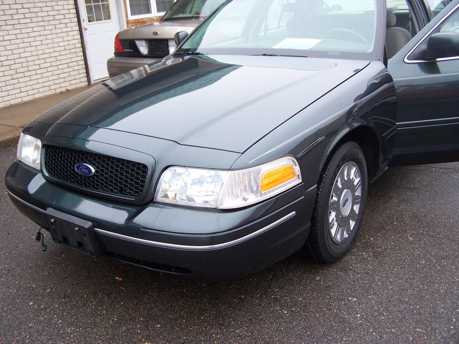 Dark green 2001 Ford Crown Victoria front 3/4 view with passenger door open