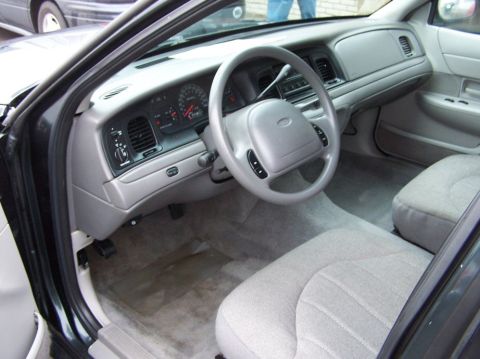 2001 Ford Crown Victoria - Interior view of a 2001 Ford Crown Victoria, highlighting the dashboard and seating.