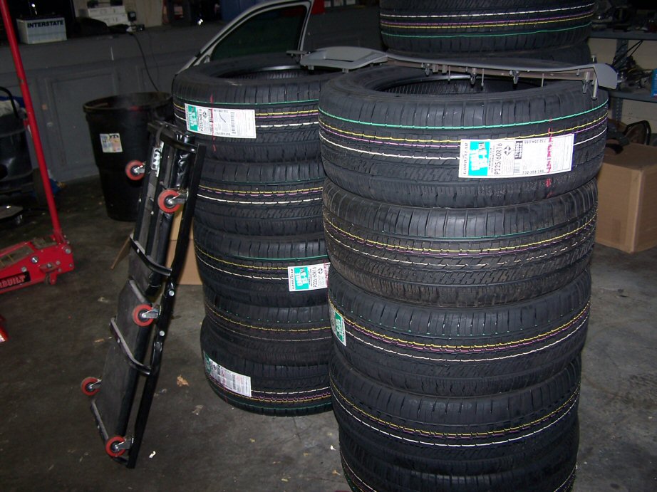 Stacks of new tires with labels visible