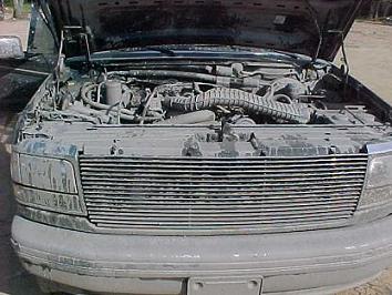 1993 Ford Bronco - Dust-covered 1992 Ford Bronco with hood open, revealing the engine compartment and front grille.