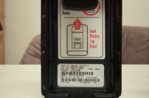 2001 Ford Crown Victoria - Close-up of a Motorola radio part, showing instructions for battery installation and a serial number label.