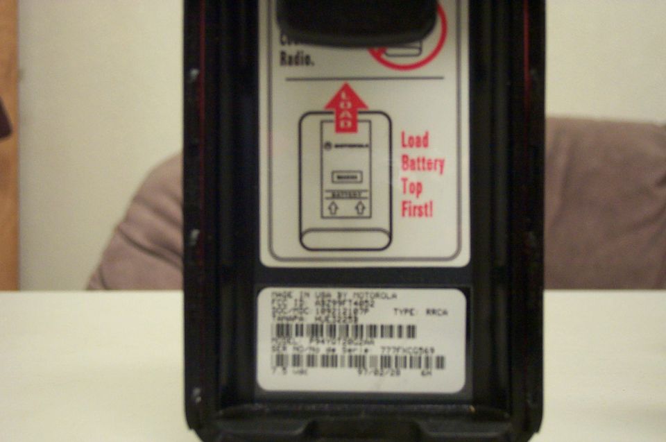 Motorola radio part with instructions to load battery top first and serial number