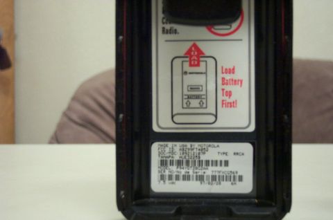 2001 Ford Crown Victoria - Label inside a Motorola radio shows how to load the battery and provides model and serial number details.