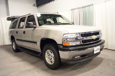 2001 Ford Crown Victoria - This silver SUV, likely a Chevrolet Tahoe or Suburban from the early 2000s, is shown from the front 3/4 angle. The grille features the Chev…
