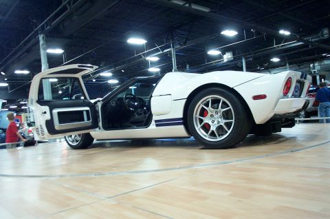 2001 Ford Crown Victoria - White Ford GT sports car with gullwing doors open, interior and wheels visible.