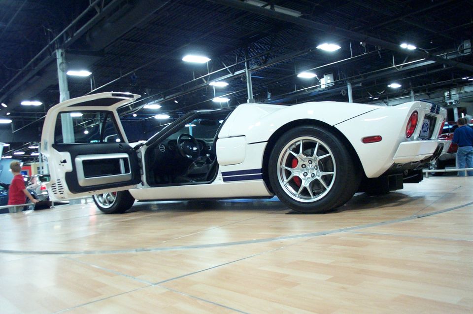 White Ford GT sports car with gullwing doors open, showing interior and wheels