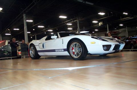 2001 Ford Crown Victoria - A white Ford GT with blue racing stripes is displayed indoors, with "FORD GT" visible on the side.