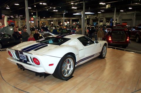 2001 Ford Crown Victoria - White Ford GT with blue racing stripes is displayed indoors.