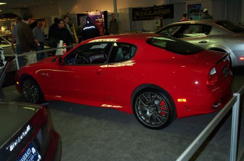 2001 Ford Crown Victoria - Red Maserati coupe on display next to a silver Maserati sedan.