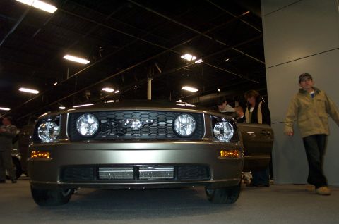 2001 Ford Crown Victoria - Bronze Ford Mustang with a distinctive grille and horse emblem is viewed from the front.