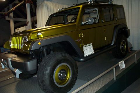 2001 Ford Crown Victoria - This modified Jeep Wrangler features a unique grille and wheel design, displayed indoors.