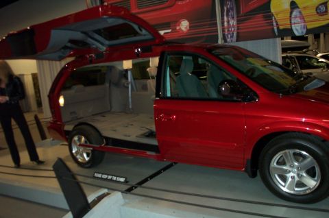 2001 Ford Crown Victoria - A red minivan is displayed with its doors and tailgate open, revealing its interior.