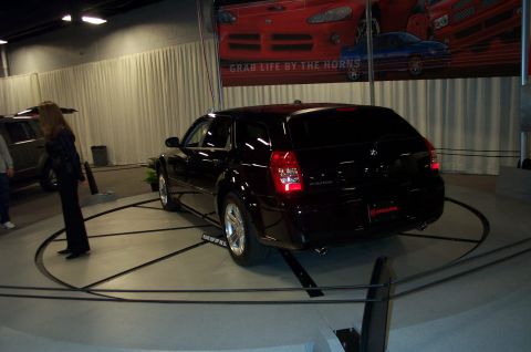 2001 Ford Crown Victoria - A black Dodge Magnum wagon is displayed on a rotating platform at an auto show.