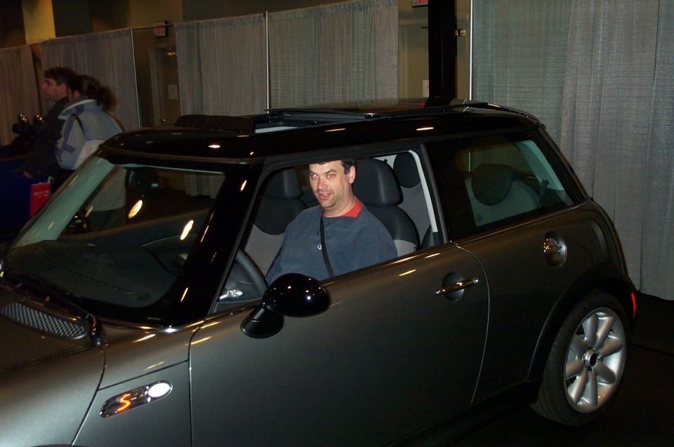 Gray Mini Cooper S with black roof and sunroof, driver's side view
