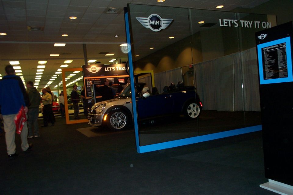 Mini Cooper convertible on display with 'Let's Try It On' sign